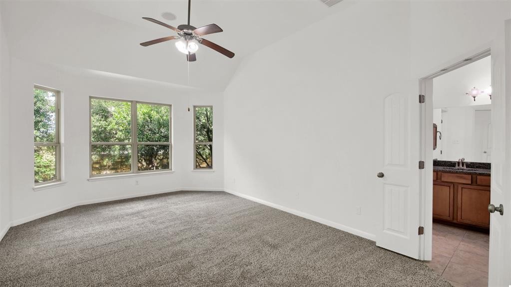 104 Lost Ridge Way Buda, TX 78610 - Photo 19 of 22 a view of a kitchen with a stove cabinets and a window