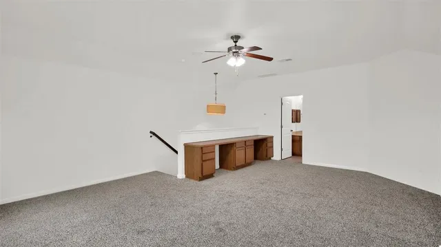 a view of an empty room with a fan