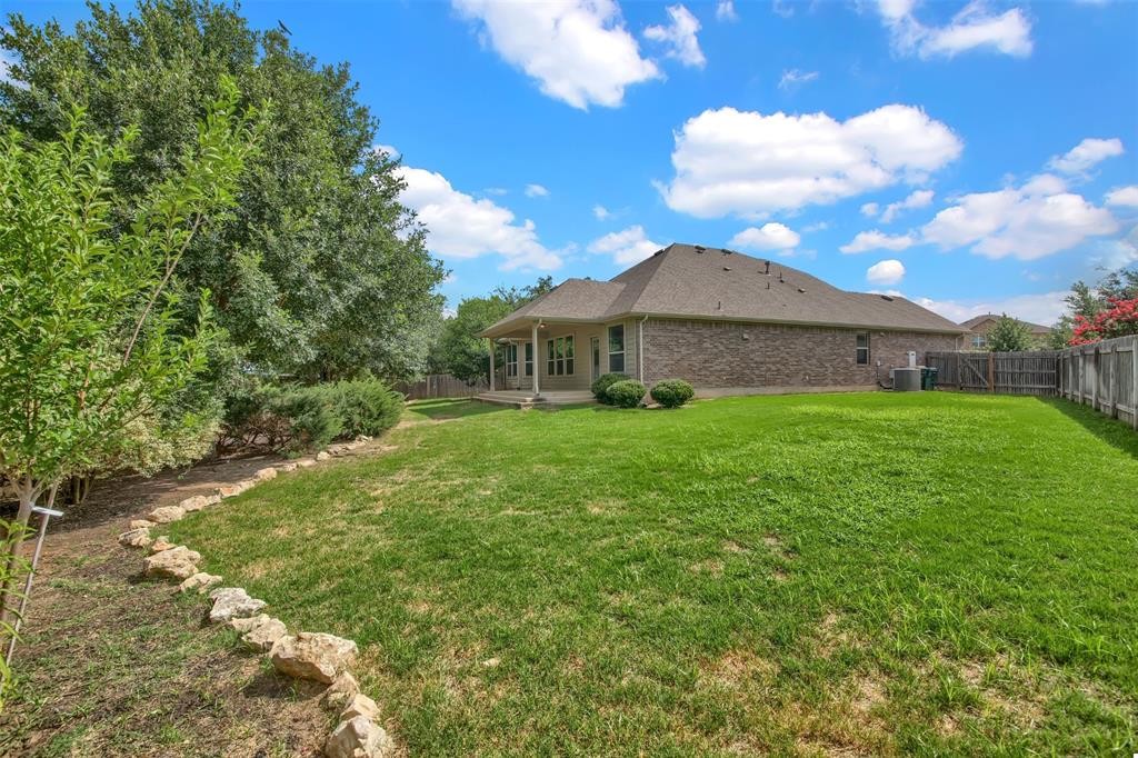 104 Lost Ridge Way Buda, TX 78610 - Photo 22 of 22 a view of a house with a yard
