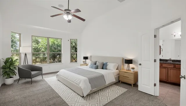 a bedroom with bed and a chandelier