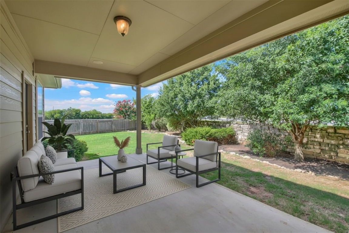 104 Lost Ridge Way Buda, TX 78610 - Photo 6 of 22 a balcony with furniture and a garden