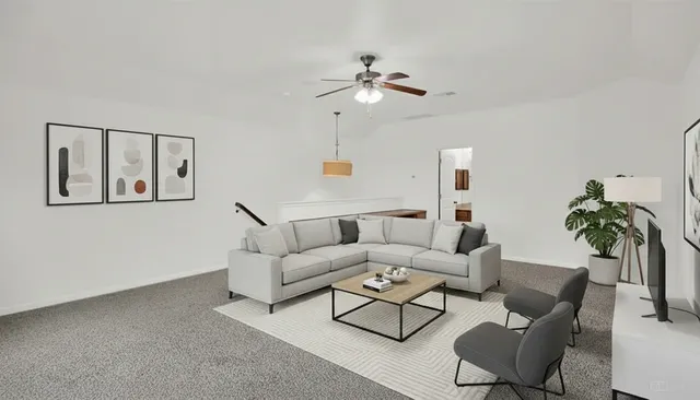 a living room with furniture and a potted plant