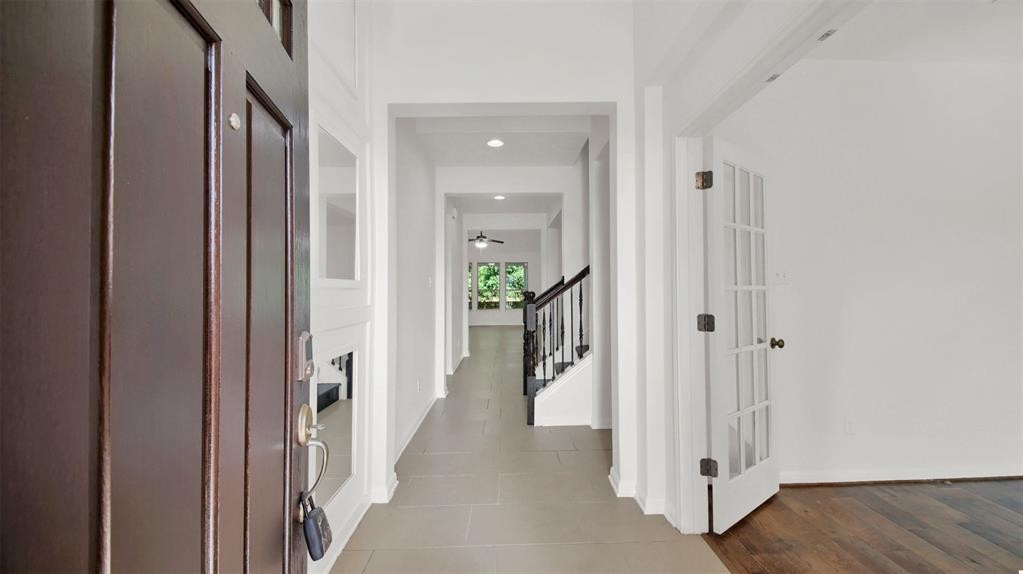104 Lost Ridge Way Buda, TX 78610 - Photo 9 of 22 a view of a hallway with wooden floor and a livingroom