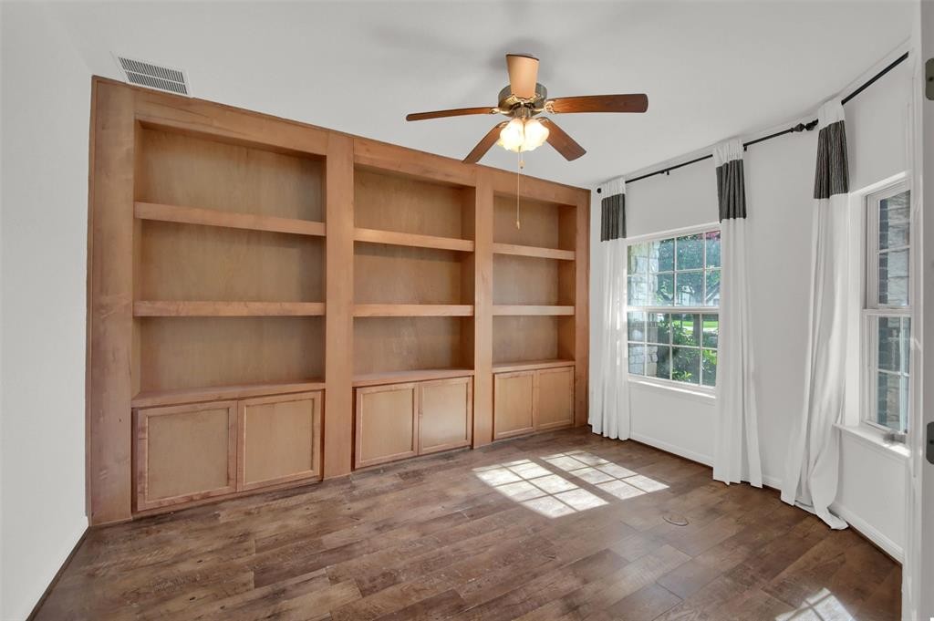 104 Lost Ridge Way Buda, TX 78610 - Photo 10 of 22 a view of empty room with wooden floor and fan