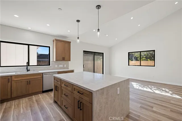 a kitchen with a stove sink and cabinets