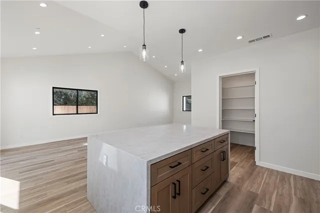 a kitchen with a wooden floor and window