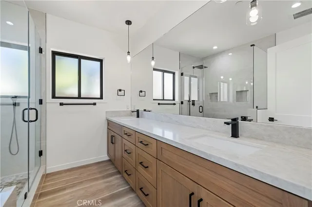 a bathroom with a double vanity sink mirror and double