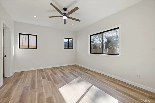 a view of empty room with wooden floor