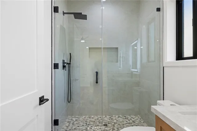 a bathroom with a shower and a sink