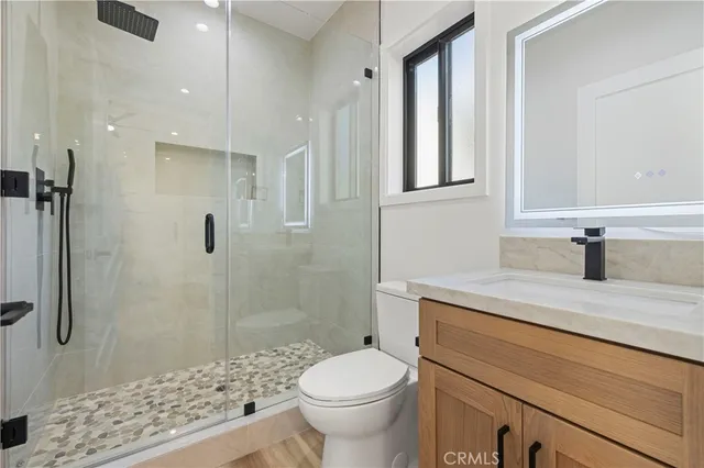 a bathroom with a sink toilet and shower