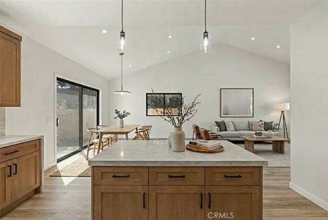 a kitchen with counter top space and living room view
