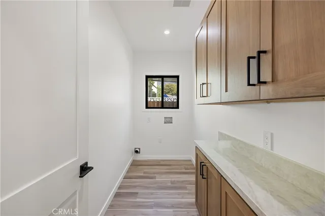 a view of a kitchen with cabinets and wooden floor