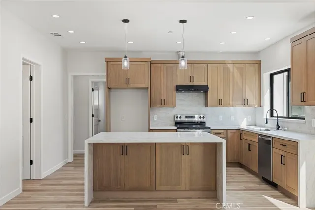 a kitchen with a stove a sink and a refrigerator