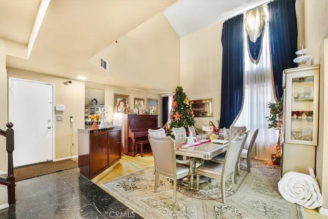 a dining room with furniture a rug and wooden floor