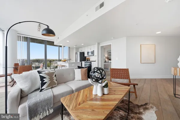 a living room with furniture chess table and a large window