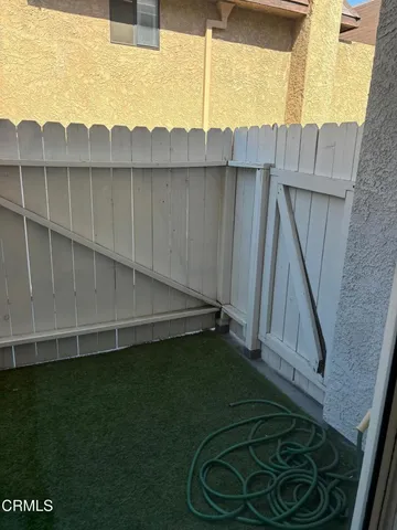 a view of a backyard with wooden fence