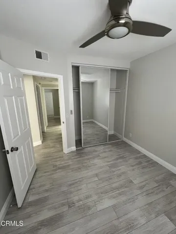 a view of a room with wooden floor and staircase