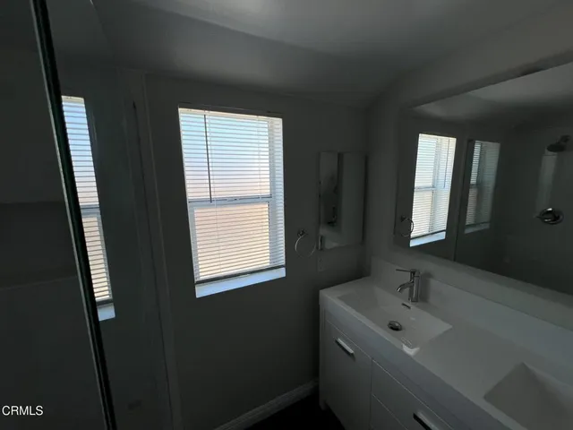 a bathroom with a sink and a window