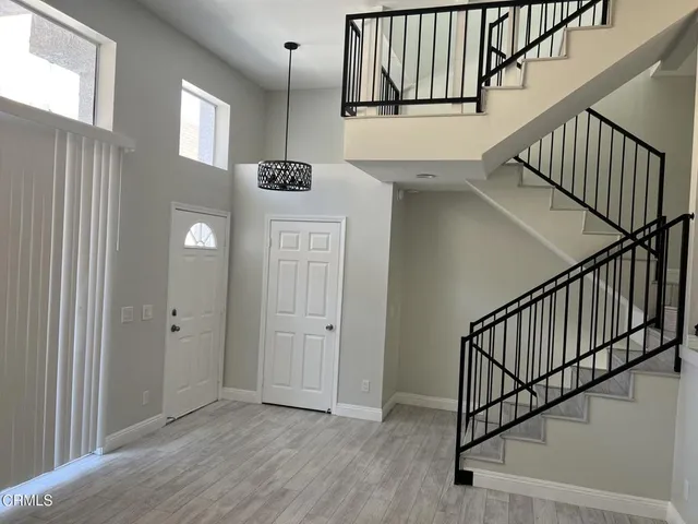 a view of an entryway with wooden floor