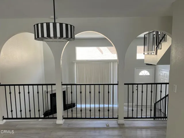 a view of staircase with white walls and railing