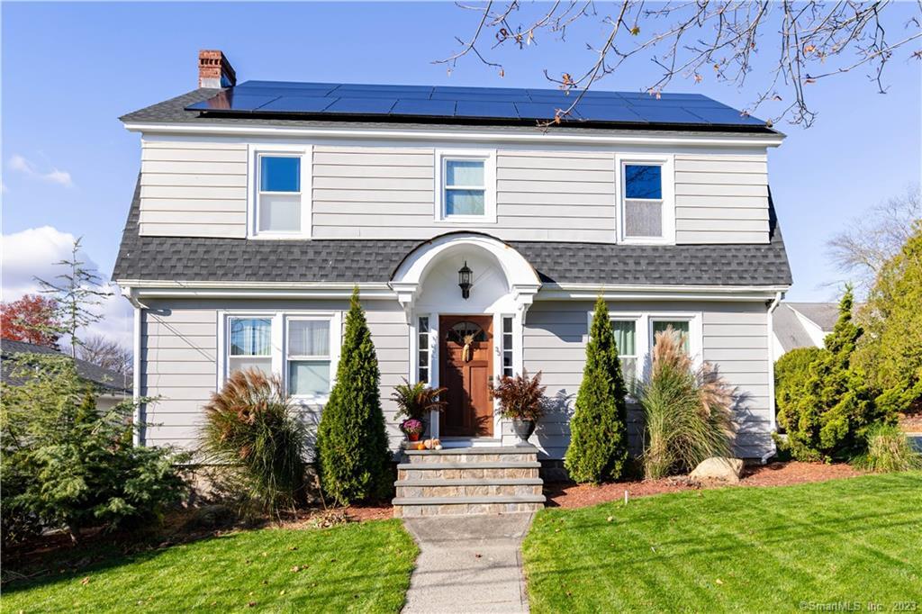 a front view of a house with garden