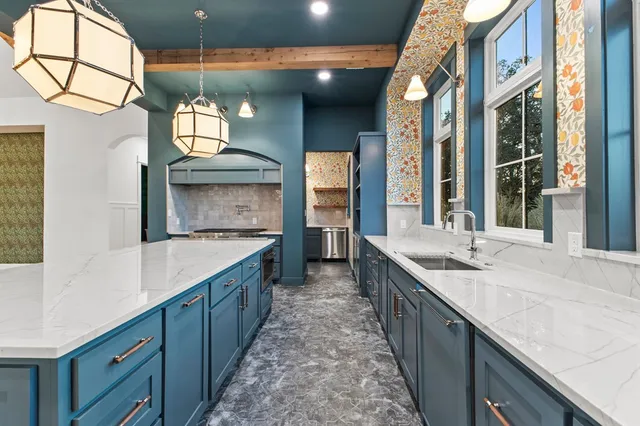 a large kitchen with stainless steel appliances double vanity and a sink