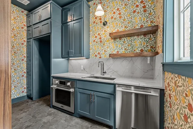 a kitchen with stainless steel appliances a stove and a refrigerator