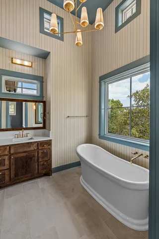 a bathroom with a bathtub and window