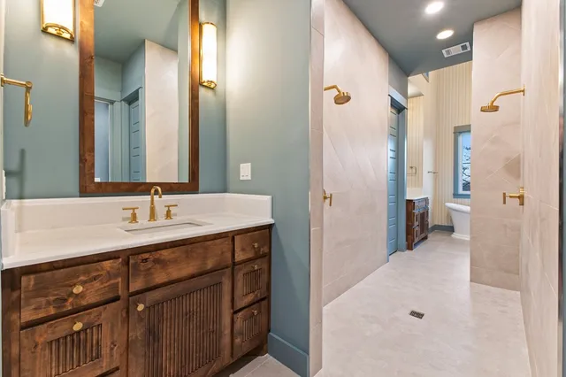 a bathroom with a double vanity sink and a mirror