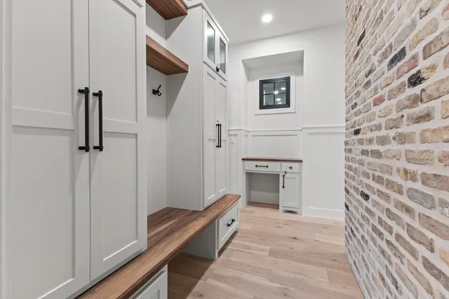 a view of hallway with a glass door and chandelier