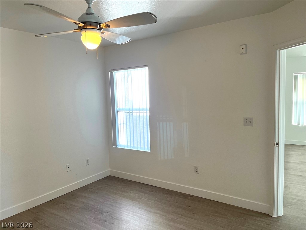 7255 West Sunset Road, Unit 2141 Las Vegas, NV 89113 - Photo 8 of 15 Crisp walls and smooth wood-style flooring create a clean slate in this versatile room.