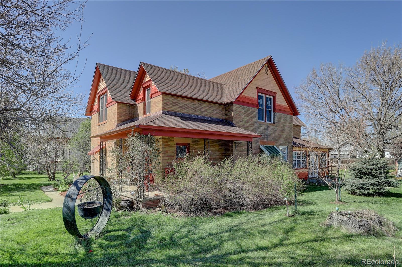 153 Park Avenue Fort Lupton, CO 80621 - Photo 1 of 35 a front view of a house with garden
