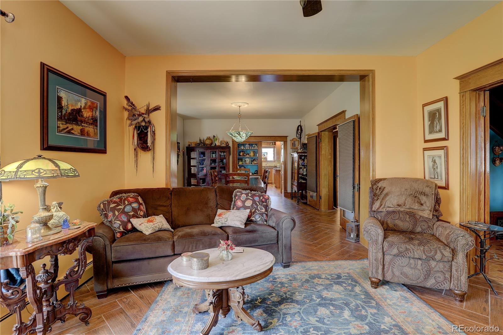 153 Park Avenue Fort Lupton, CO 80621 - Photo 12 of 35 a living room with furniture and a wooden floor