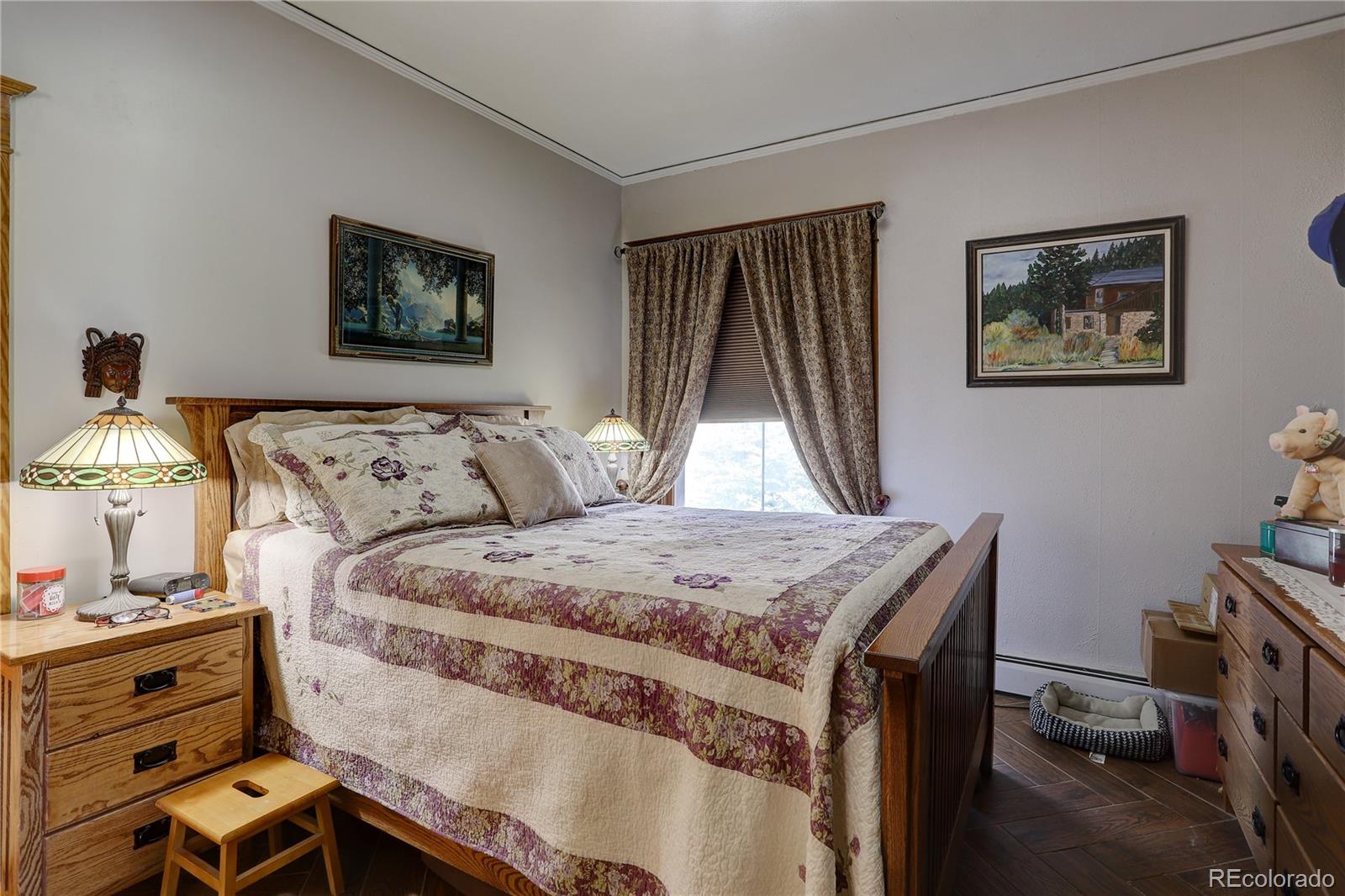 153 Park Avenue Fort Lupton, CO 80621 - Photo 18 of 35 a bedroom with a bed and a dresser