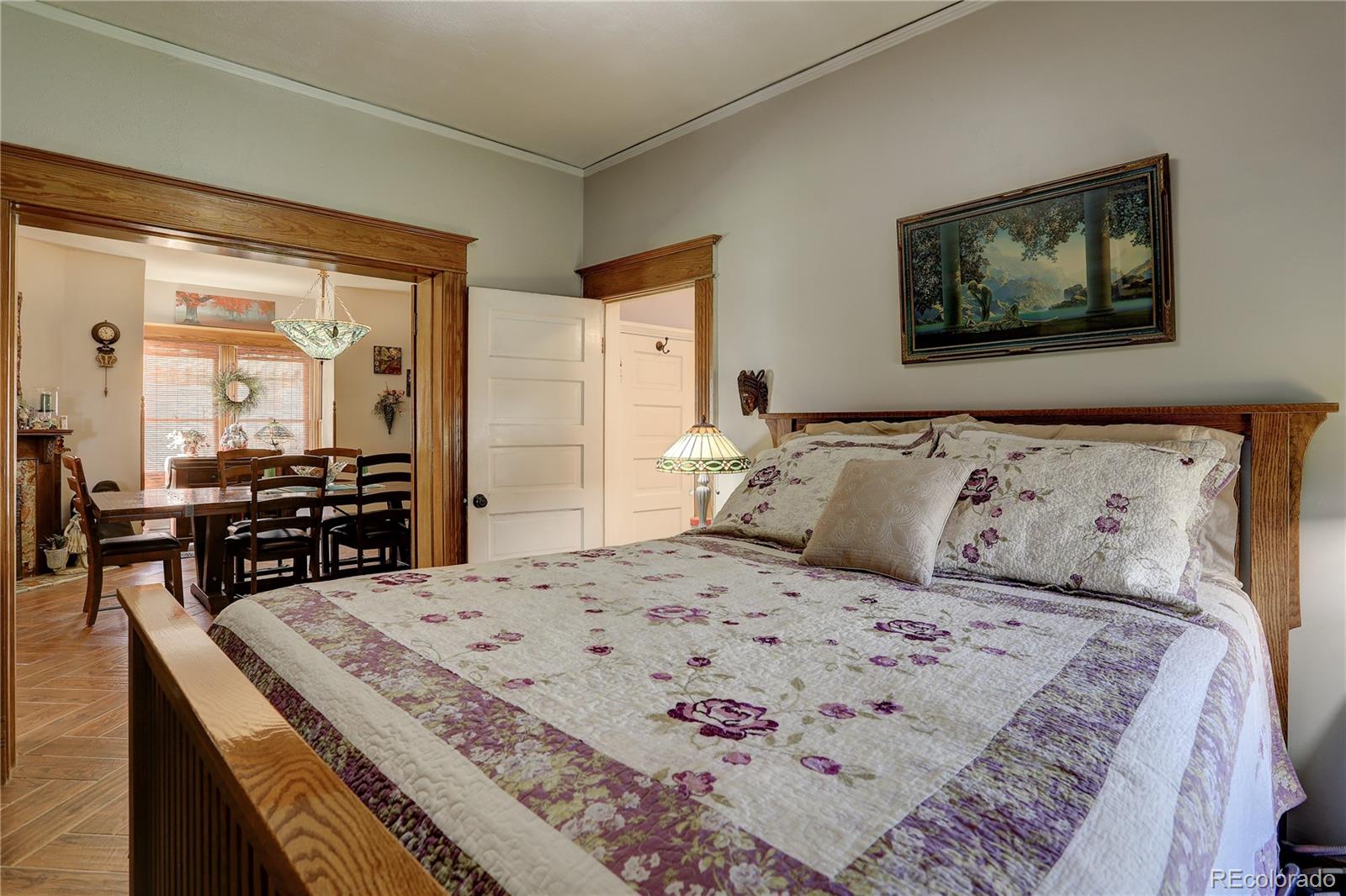 153 Park Avenue Fort Lupton, CO 80621 - Photo 19 of 35 a large bedroom with a bed a table and chair