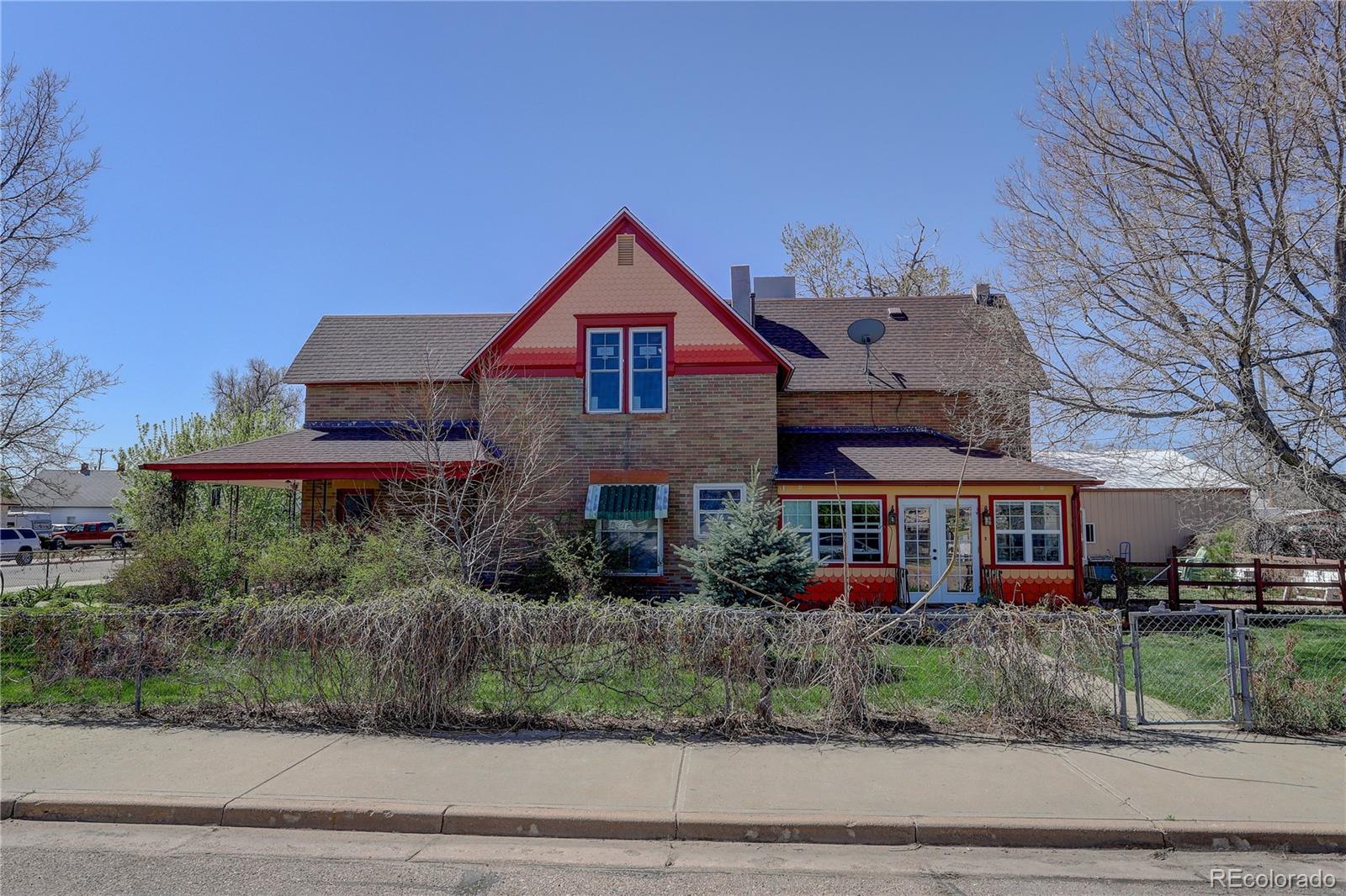 153 Park Avenue Fort Lupton, CO 80621 - Photo 2 of 35 a front view of a house with a yard