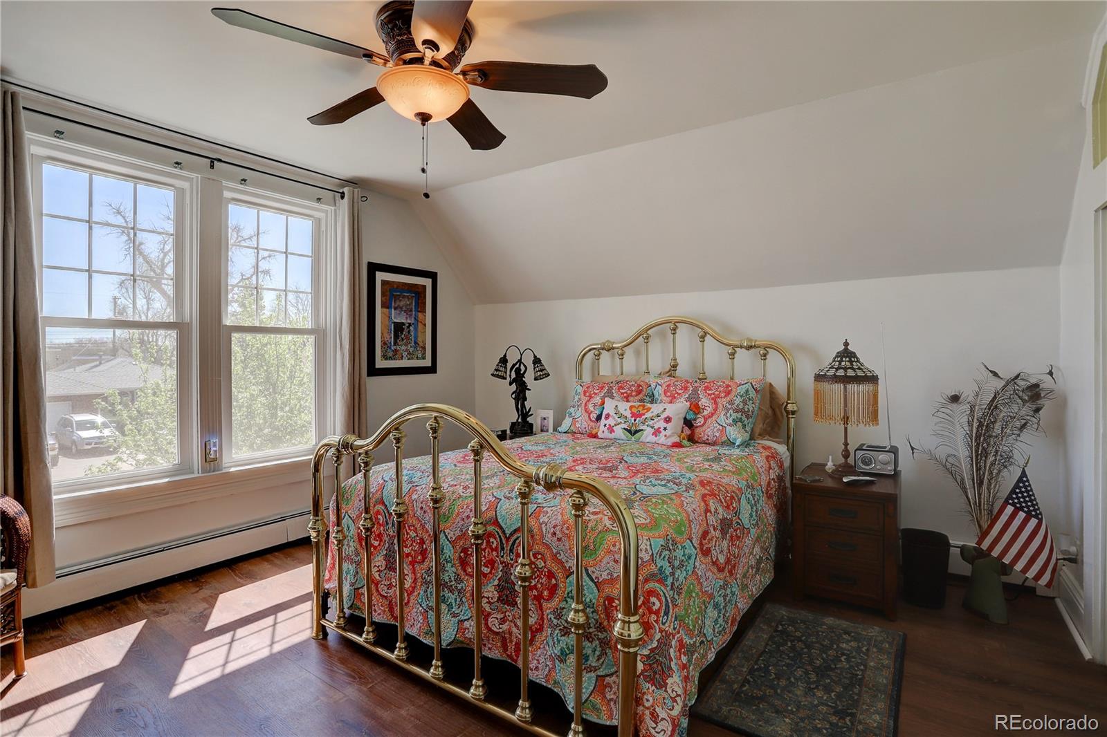 153 Park Avenue Fort Lupton, CO 80621 - Photo 22 of 35 a bedroom with a bed and a large window with the outer view