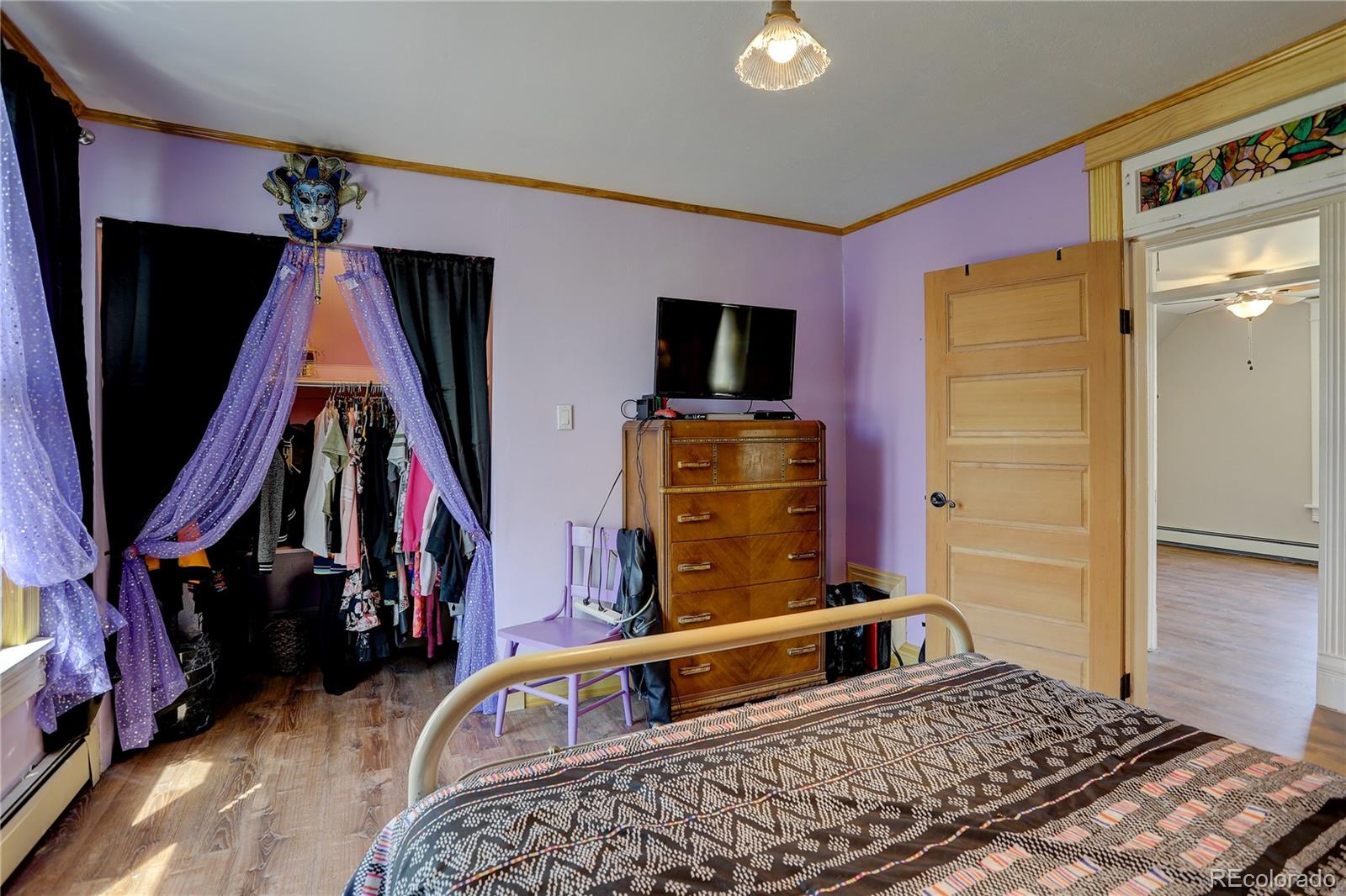 153 Park Avenue Fort Lupton, CO 80621 - Photo 25 of 35 a living room with furniture and a flat screen tv