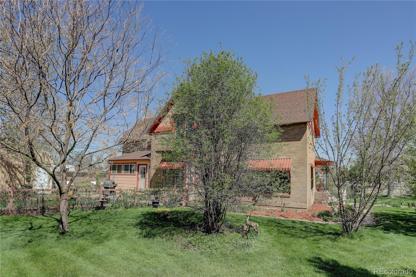 153 Park Avenue Fort Lupton, CO 80621 - Photo 33 of 35 a backyard of a house with lots of green space
