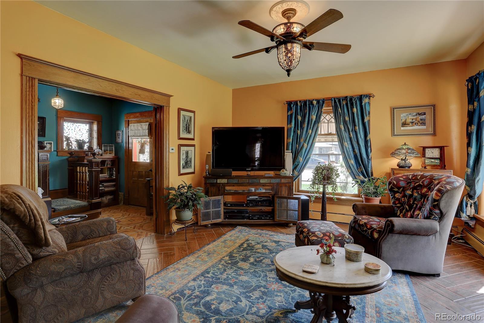 153 Park Avenue Fort Lupton, CO 80621 - Photo 5 of 35 a living room with furniture and a flat screen tv