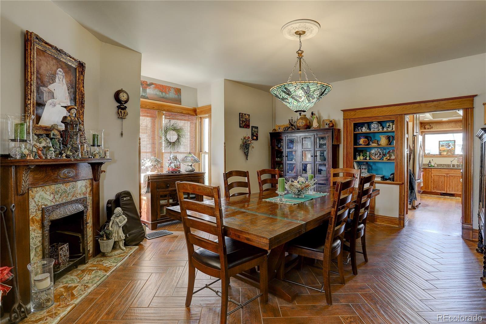 153 Park Avenue Fort Lupton, CO 80621 - Photo 7 of 35 a view of a dining room with furniture window and wooden floor