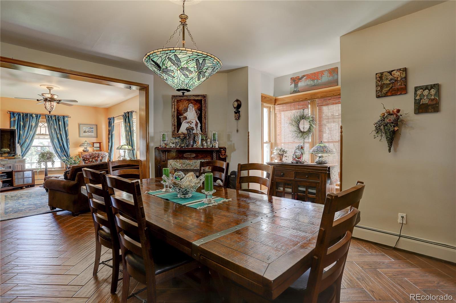 153 Park Avenue Fort Lupton, CO 80621 - Photo 8 of 35 a view of a dining room with furniture window and wooden floor