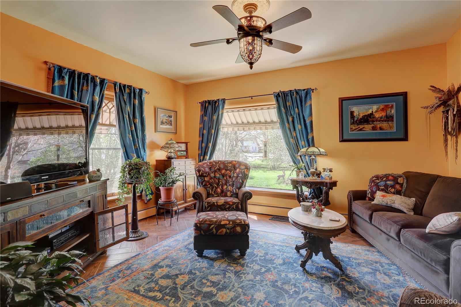 153 Park Avenue Fort Lupton, CO 80621 - Photo 10 of 35 a living room with furniture and a flat screen tv