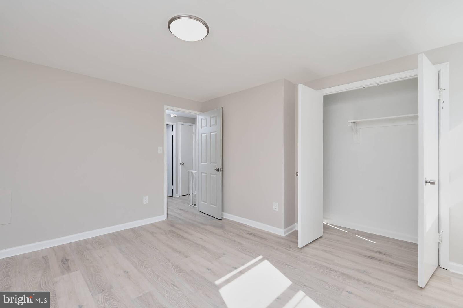 1842 Dutch Village Drive, Unit R264 Landover, MD 20785 - Photo 20 of 26 an empty room with wooden floor and windows