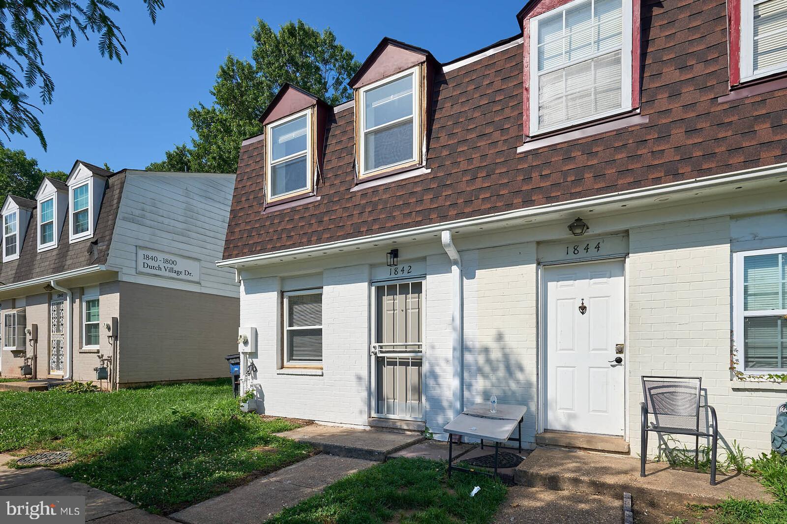 1842 Dutch Village Drive, Unit R264 Landover, MD 20785 - Photo 2 of 26 a front view of a house with a yard