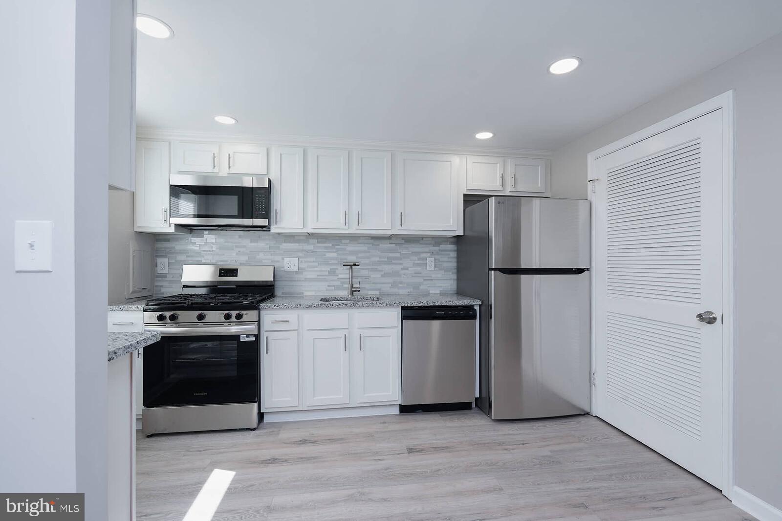 1842 Dutch Village Drive, Unit R264 Landover, MD 20785 - Photo 3 of 26 a kitchen with stainless steel appliances a refrigerator sink and stove