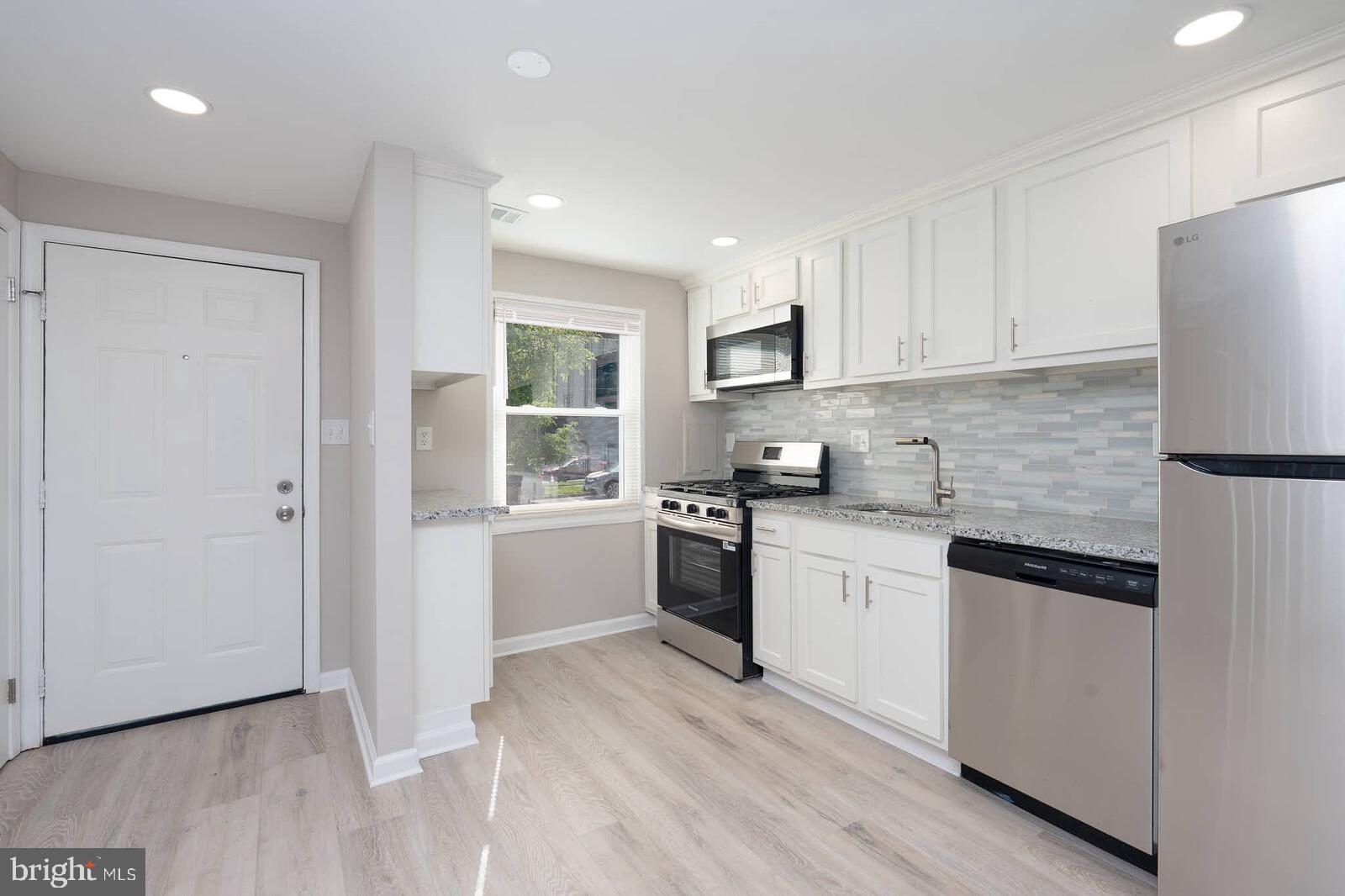 1842 Dutch Village Drive, Unit R264 Landover, MD 20785 - Photo 4 of 26 a kitchen with a refrigerator stove top oven and sink