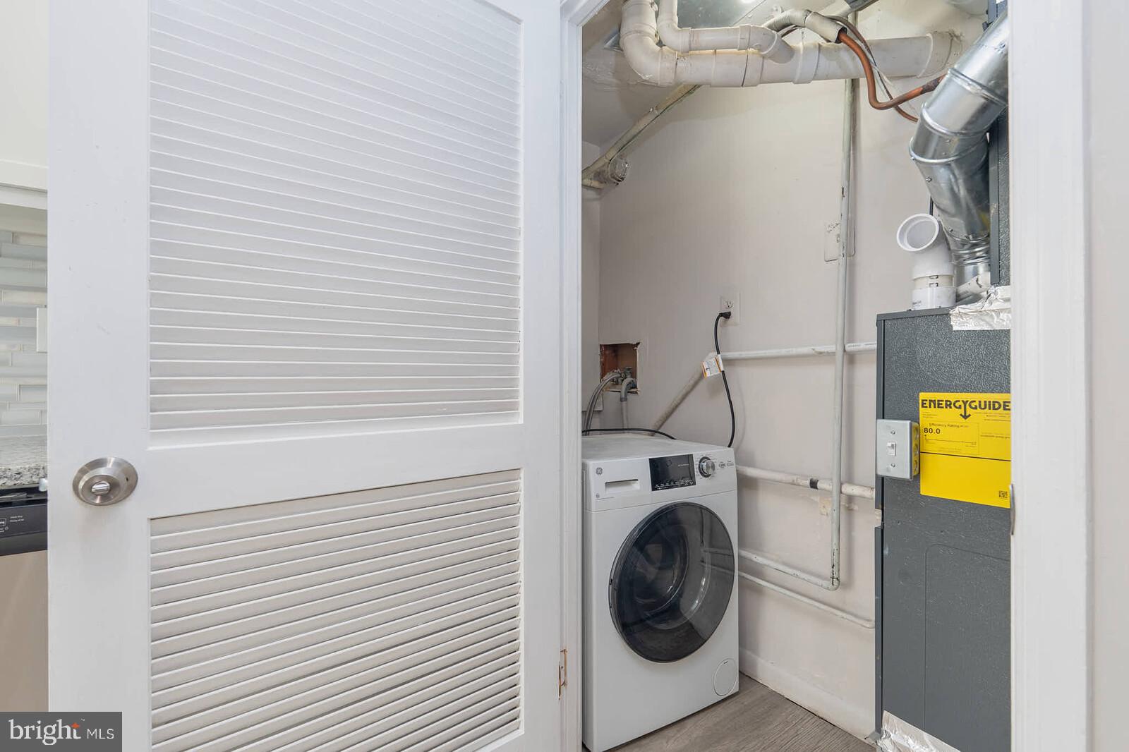1842 Dutch Village Drive, Unit R264 Landover, MD 20785 - Photo 9 of 26 a utility room with dryer and washer