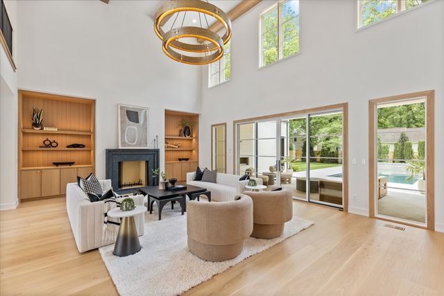 a room with furniture potted plants and wooden floor