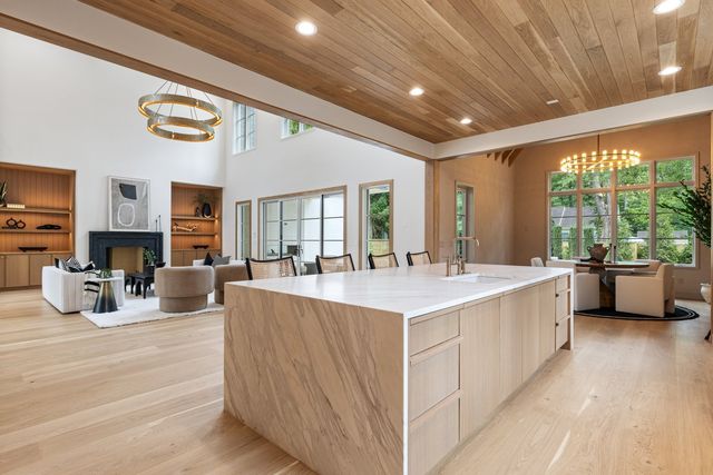 a kitchen with stainless steel appliances granite countertop a sink and a refrigerator